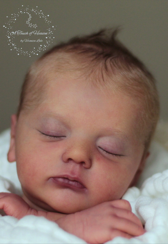 Realistic sleeping baby doll.