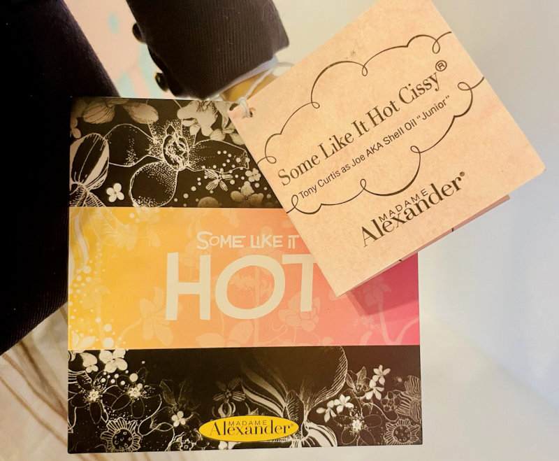 Closeup of tags for Madame Alexander's Tony Curtis doll. The wrist tag says "Some Like It Hot Cissy / Tony Curtis as Joe AKA Shell Oil 'Junior'"