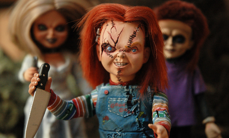 Chucky, one of the most famous doll villains, wields a knife.
