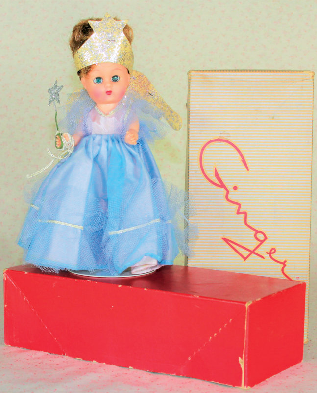 Plastic doll wearing a Disney Blue Fairy outfit.