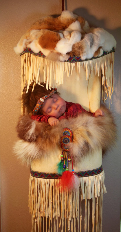 RuBert’s artist proof of her papoose doll (21 inches) has a cloth body with silicone head, arms, and legs. “The doll and carrier will undergo changes until I am happy with the result,” the artist said.