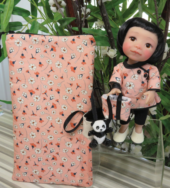 Pat Moulton's 8-inch BJD Lilly comes with face-up, two tote bags, resin panda, and zipper travel pouch all designed by the artist, and an outfit by Bonnie Larson of Wee Designs.