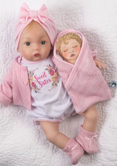Sweet Sister from Paradise Galleries wears a turban and has her own little cloth baby doll. She exudes Old Hollywood glamour, infant style.
