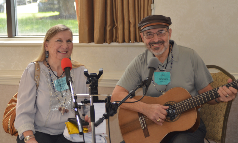 Artist Linda Trinckes and her husband John sing doll and teddy bear songs, which they composed, to entertain those waiting for the doors to open on the Quinlans’ Saturday Show & Sale.