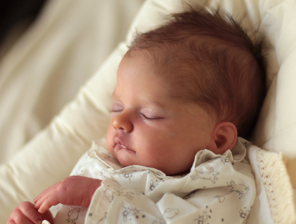 Realistic sleeping baby doll.