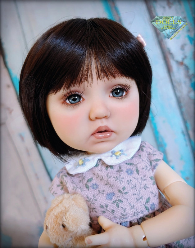 Sylvia Scarlett, an 11-inch Dumpling BJD from Meadow Dolls. She was painted with high pigment acrylics and soft chalks. I cut a heat-stylable wig to give it a more youthful look and gave her peaceful gray eyes to balance out her dark hair.