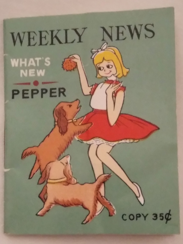 A booklet showing a girl playing with two dogs on the cover. It's titled "Weekly News" and says "What's New - Pepper" and "Copy 35 cents" on the cover.
