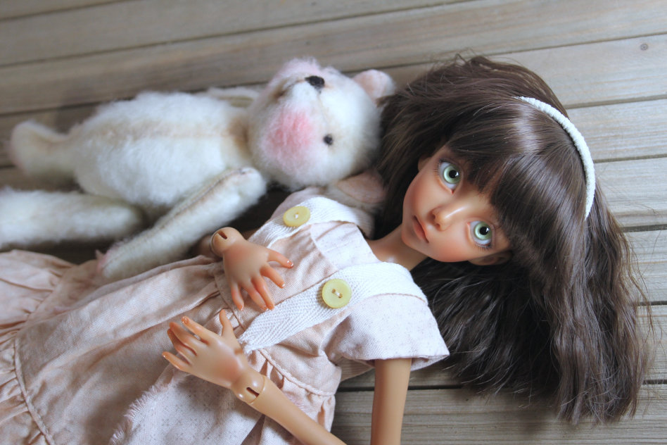 A teen BJD with a teddy bear.